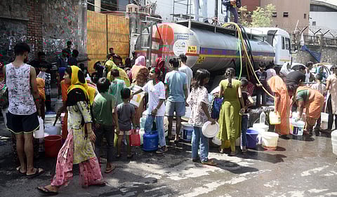Residents fill water from a tanker amid water crisis in New Delhi.