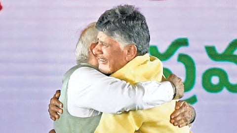 Prime Minister Narendra Modi embraces N Chandrababu Naidu (right) soon after the latter was sworn-in as Chief Minister