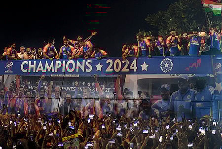 Mumbai: Players of the T20 World Cup-winning Indian cricket team with the championship trophy acknowledge fans during their open bus victory parade