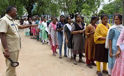 Candidates attend UPSC recruitment test for the post of nursing officer at SPW Junior College in Tirupati on Sunday. 