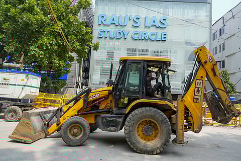 Excavators parked during an anti-encroachment drive by MCD in Old Rajinder Nagar, after three civil services aspirants died at a coaching centre due to drowning, in New Delhi,