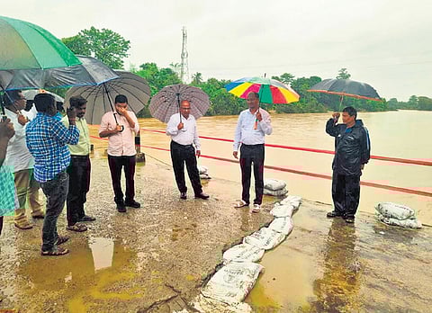 Senior officials at a low-lying bridge in Potteru.