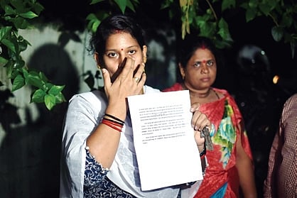 Pradhan’s wife Sajoja showing the complaint copy to the media