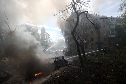 Ukrainian firefighters work to extinguish a fire at the site of a missile attack in Kyiv on July 8, 2024.