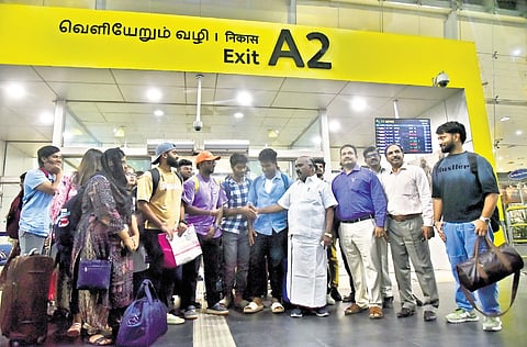 Minister Gingee Masthan receiving students arriving from Bangladesh in  Chennai  airport on Sunday