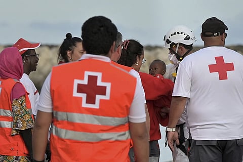 A baby is carried by members of the Red Cross in the port of La Restinga at El Hierro in the Canary Islands on Saturday, June 6, 2024, after being rescued by the Spanish Sea Rescue.