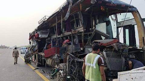 Mangled remains of a bus being towed after an accident, in Unnao district.