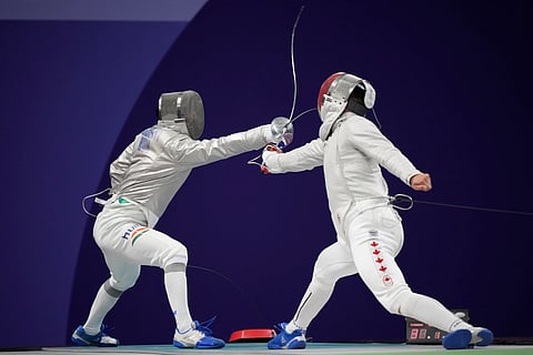 Hungary's Aron Szilagyi, left, and Canada's Fares Arfa compete in the men's individual Sabre round of 32 competition during the 2024 at the Grand Palais, 