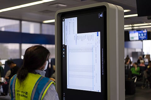 A technician works on an information display near United Airlines gates at Chicago O'Hare International Airport in Chicago, Friday, July 19, 2024, after a faulty CrowdStrike update caused a major internet outage for computers running Microsoft Windows.