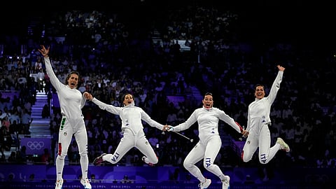 Italy's Alberta Santuccio, second right, celebrates with her teammates Rossella Fiamingo, second left, Giulia Rizzi, left, and Mara Navarria after winning the women's team Epee final match against France during the 2024 Summer Olympics at the Grand Palais.