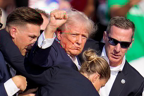 Republican presidential candidate former President Donald Trump is helped off the stage by U.S. Secret Service agents at a campaign event in Butler.