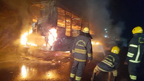 Fire fighters putting off fire on Omni bus at Chothode bye pass in Erode district on Thursday early hours. which came from Chennai to Coimbatore no causality occurred.