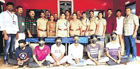 The busted gang of six with police personnel on Tuesday