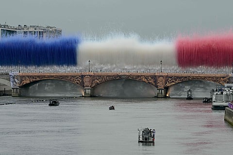 Indian athletes wave their national flags from a boat on the Seine River in Paris, France, during the opening ceremony of the 2024 Summer Olympics, Friday, July 26, 2024.