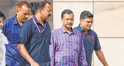 Chief Minister Arvind Kejriwal with ED officials.