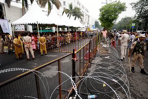 Security personnel stand guard as pilgrims wait to register for the annual Amarnath Yatra at Saraswati Dham Railway Station, in Jammu, 