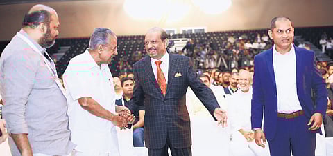 Chief Minister Pinarayi Vijayan shakes hands with Lulu Group chairman Yusuffali M A at the inaugural function of the International GenAI Conclave at Lulu Hyatt Bolgatty International Convention Centre on Thursday. Industries Minister P Rajeeve and IBM senior vice-president Dinesh Nirmal are also seen 