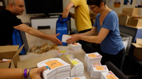 Local city officials prepare voting kits for the legislative election in Strasbourg, eastern France, on Saturday, July 6, 2024.