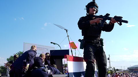 Republican presidential candidate former President Donald Trump is covered by U.S. Secret Service agents at a campaign rally.