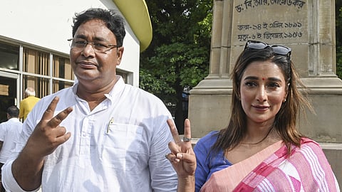 Newly elected TMC MLAs Rayat Hossain Sarkar and Sayantika Banerjee flash victory sign after taking the oath of office administered by West Bengal Assembly Speaker Biman Banerjee, at the state Legislative Assembly, in Kolkata.