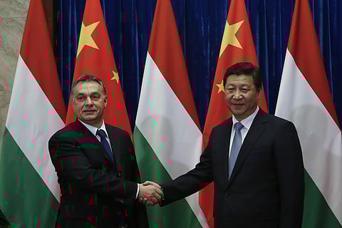 Hungary Prime Minister Viktor Orban, left, and Chinese President Xi Jinping, right, shake hands before a meeting at the Great Hall of the People in Beijing, China, Feb. 13, 2014.