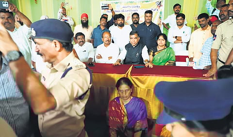 P Sabitha Indra Reddy on Monday sat on the floor in protest as she was not invited to the dais