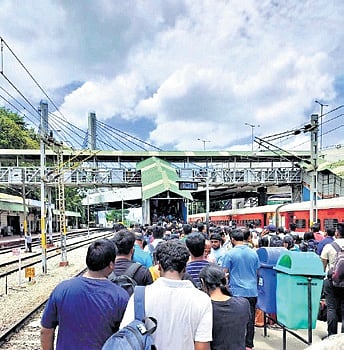 Passengers jostle to make their way through one of the narrow staircases 
at KR Puram Railway Station | EXPRESS