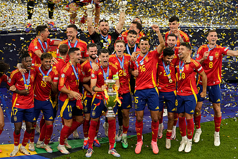 Spain's players celebrate with the trophy after winning the final match between Spain and England at the Euro 2024 soccer tournament in Berlin, Germany, Sunday, July 14, 2024.