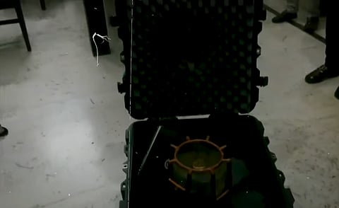 A black box was found with a warning label indicating that it contained radioactive material and opening it could pose a radiation hazard.