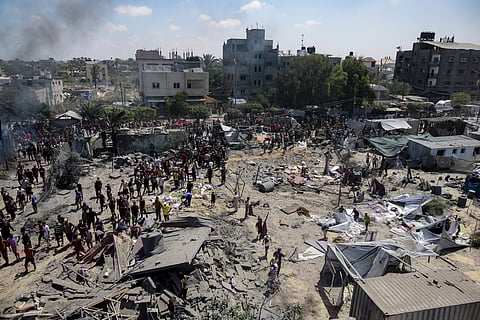 Palestinians inspect the damage at a site hit by an Israeli bombardment on Khan Younis, southern Gaza Strip, Saturday, July 13, 2024. Israel said it targeted Hamas' shadowy military commander in a massive strike Saturday in the crowded southern Gaza Strip that killed at least 71 people, according to local health officials. Hamas immediately rejected the claim that Mohammed Deif was targeted.