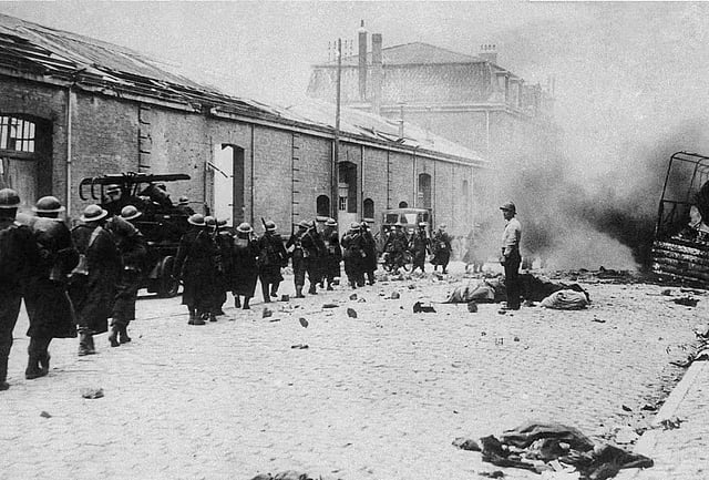British troops march down a Dunkirk street in France on June 13, 1940, heading for the ships that will take them back to England. 