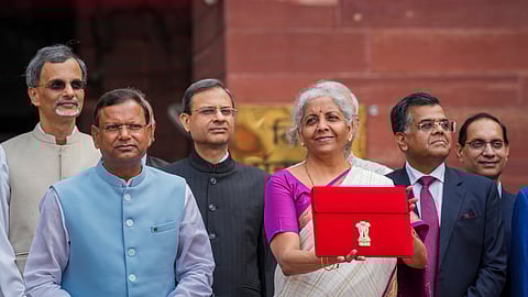 Union Finance Minister Nirmala Sitharaman displays the red pouch carrying the Budget documents outside the Finance Ministry in North Block before her presentation.