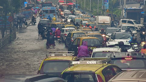 Vehicles move on a waterlogged road after heavy monsoon rain, at Dadar in Mumbai, Sunday, July 21, 2024.