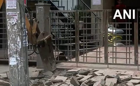 An earthmover at work, removing encroachment from Delhi's Rajinder Nagar