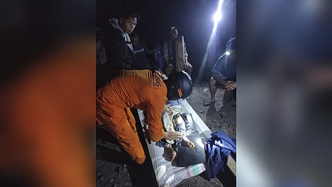 In this photo released by the Indonesian National Search and Rescue Agency (BASARNAS), an injured victim of a landslide is attended to in Suwawa on Sulawesi Island, Indonesia, early Monday, July 8, 2024.