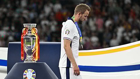 England's forward Harry Kane receives a silver medal and walks past the trophy at the end of the UEFA Euro 2024 final football match between Spain and England at the Olympiastadion in Berlin on July 14, 2024.