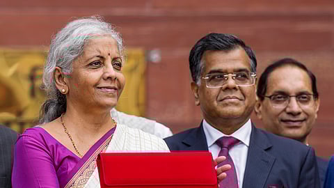 File- Union Finance Minister Nirmala Sitharaman along with Finance Secretary T V Somanathan displays a red pouch carrying the Budget documents outside the Finance Ministry in North Block before leaving for the Parliament where she will table the Union Budget 2024-25, in New Delhi, Tuesday, July 23, 2024. 