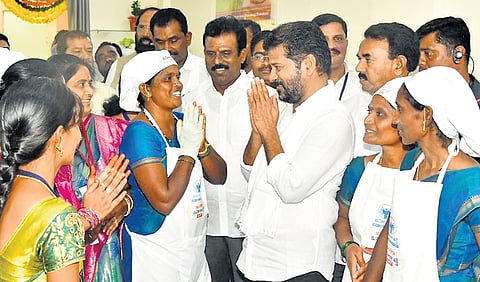 Chief Minister A Revanth Reddy greets the employees during the opening of a Mahila Shakti Canteen at the Mahbubnagar collectorate on Tuesday