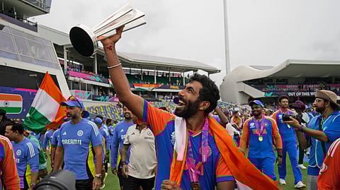 India's Jasprit Bumrah celebrates with the winners' trophy after India won the ICC Men's T20 World Cup final cricket match against South Africa at Kensington Oval in Bridgetown, Barbados, Saturday, June 29, 2024.