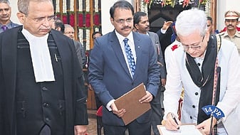 Telangana High Court Chief Justice Alok Aradhe administers the oath of office to Governor Jishnu Dev Varma in Raj Bhavan on Wednesday