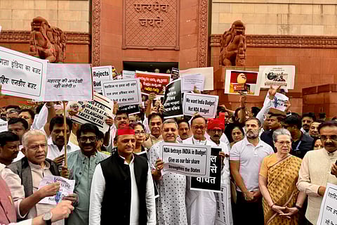 Opposition MPs protest outside the Parliament complex against the Union Budget on Wednesday.