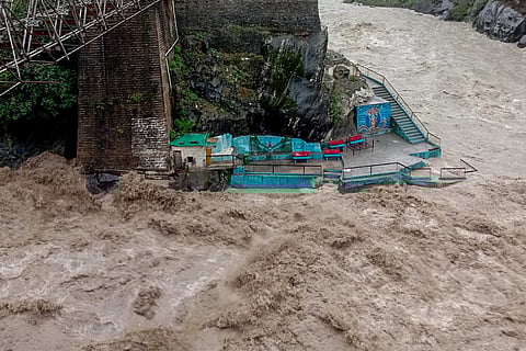 The Alaknanda River is in spate as its water level rises to the danger mark following heavy rainfall, in Chamoli on Saturday. 