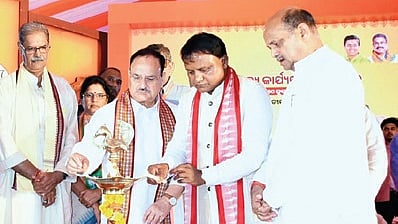 JP Nadda & CM Mohan Majhi lighting the lamp before the meeting