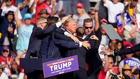 Republican presidential candidate former President Donald Trump is helped off the stage at a campaign event in Butler, Pa., Saturday, July 13, 2024.