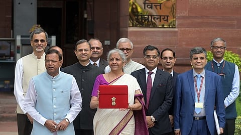 Union Finance Minister Nirmala Sitharaman displays the red pouch carrying the Budget documents outside the Finance Ministry in North Block before her presentation.