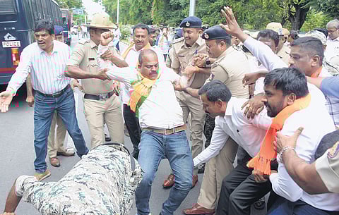Police detain BJP workers as they try to lay siege to MUDA office in Mysuru on Thursday.