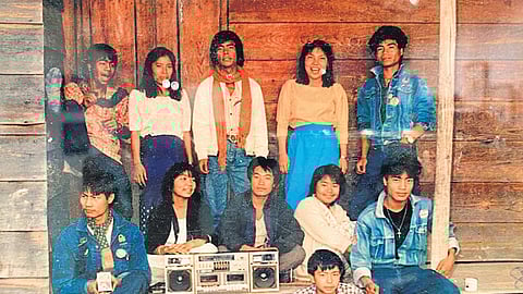 Lamka people posing around a music system
