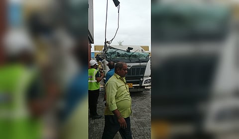 A container that was being moved by a crane operator from a ship to the Adani Ennore Container Terminal brushed against another container and fell on the vehicle.