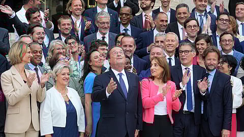 Newly elected parliament members of the Socialist party, with former French President Francois Hollande at center, pose at the National Assembly, Tuesday, July 9, 2024 in Paris.