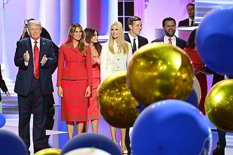 Balloons fall as former US President and 2024 Republican presidential candidate Donald Trump (L) stands alongside former US First Lady Melania Trump (2nd L) and family after he accepted his party's nomination on the last day of the 2024 Republican National Convention